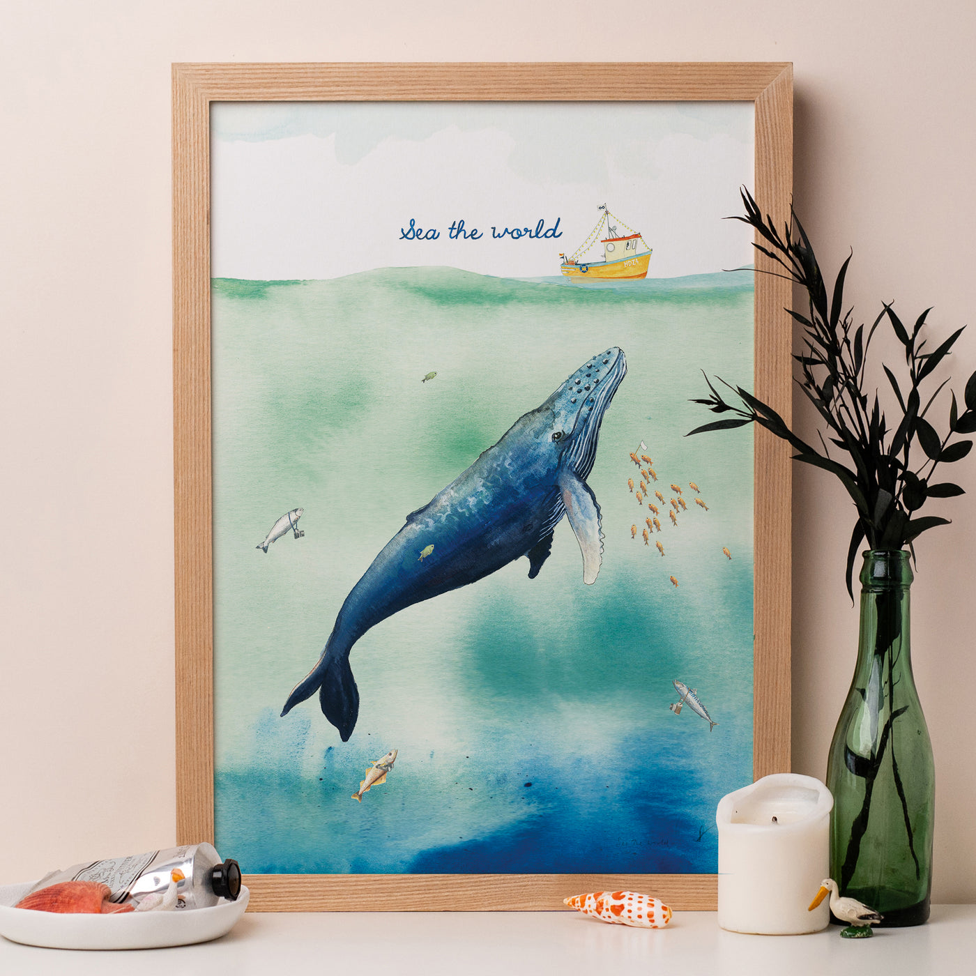 Framed illustration of a blue whale swimming in a green and blue sea