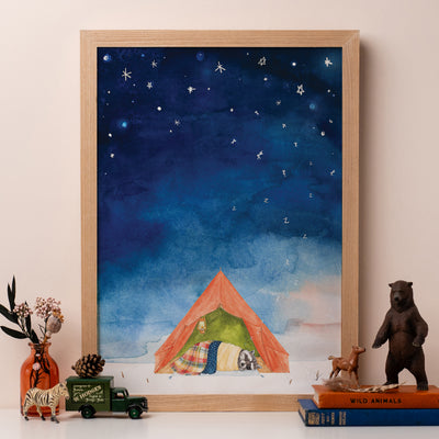 A framed print of a drawing of a raccoon snoring in a tent under the stars