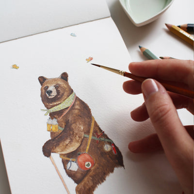 Here Bear and Everywhere Illustration with a hand painting a watercolour drawing