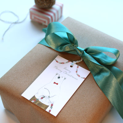 Close up of wrapped gift with Beary Merry Christmas tag