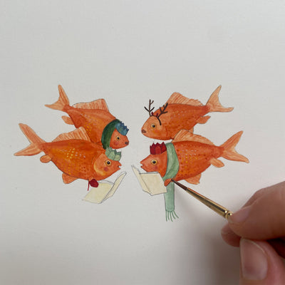Hand painting a group of watercolour goldfish